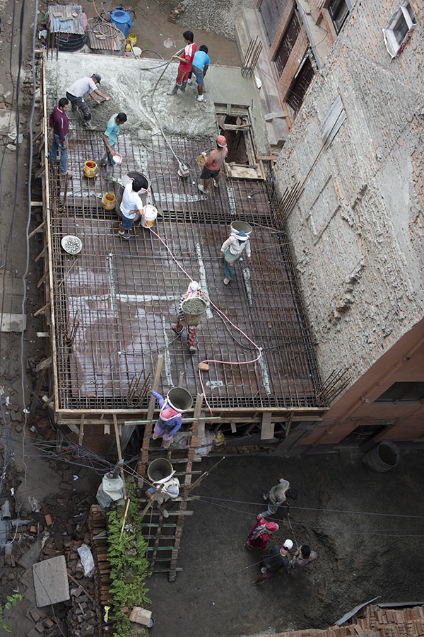 Photo of a manual concrete pour for a floor of an new builidng old Lalitpur, Nepal.